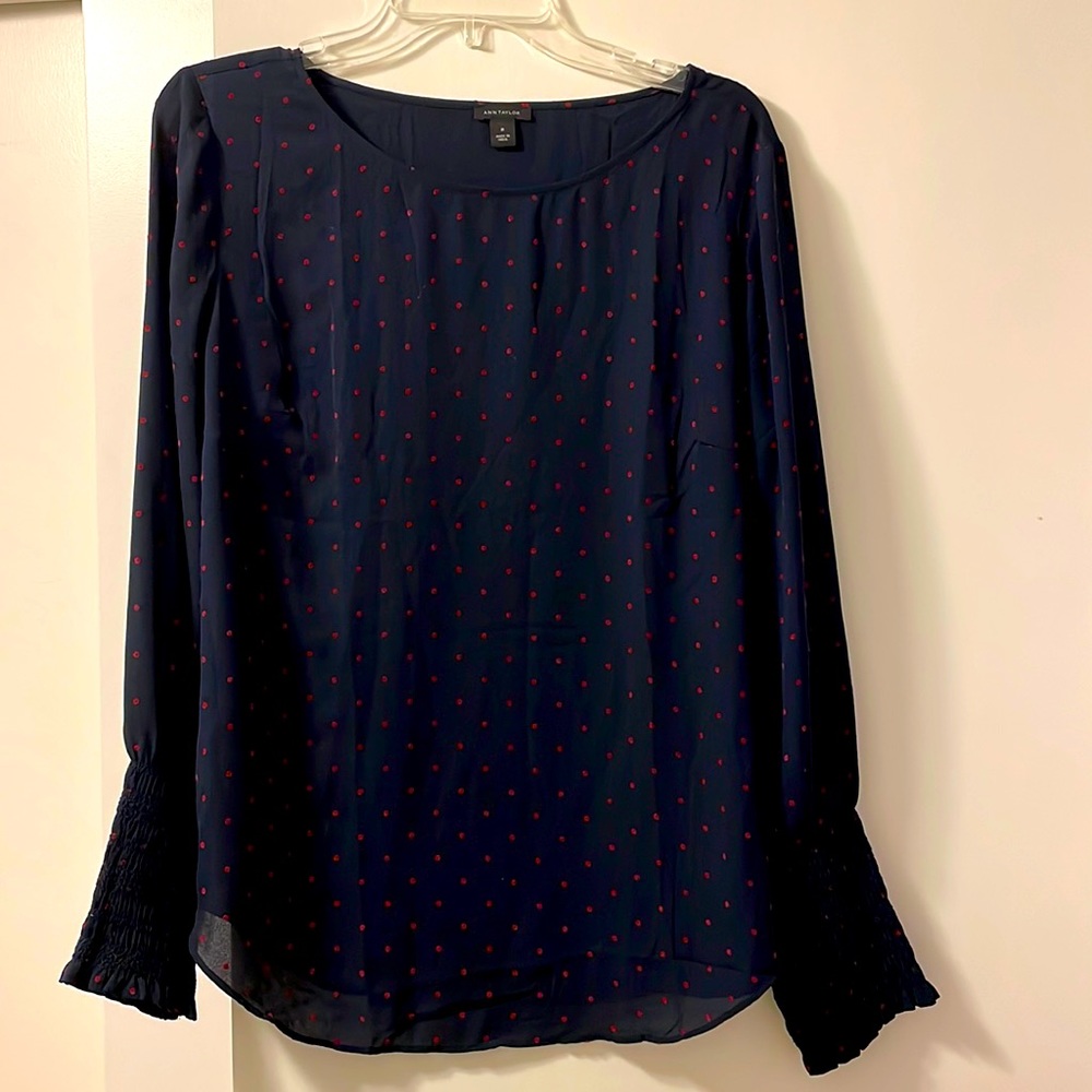 Navy shirt with red polka dots.